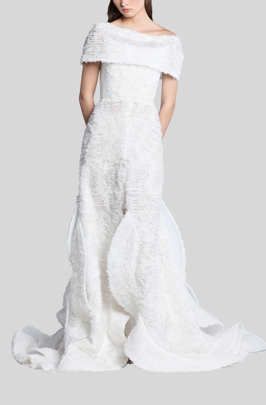 White off-shoulder dress with textured fabric on a plain background